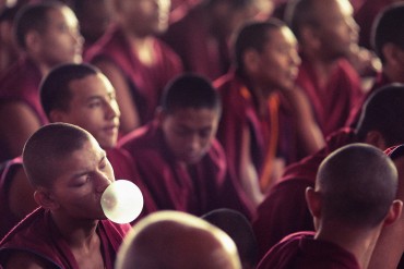 buddhist monk chewing gum in tibet