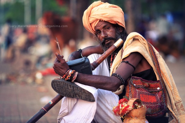 hindu man with flute in turban in haridvar in india