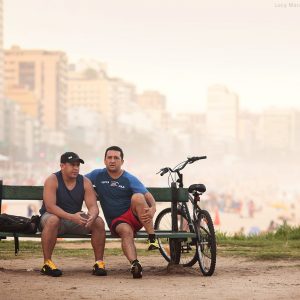 two men on a bench in rio de janeiro in brazil