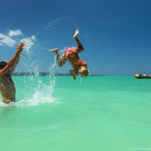 girl is jumping in turquiose sea on havelock island in andaman in india