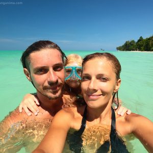 family selfie in turquiose sea on havelock island in andaman in india